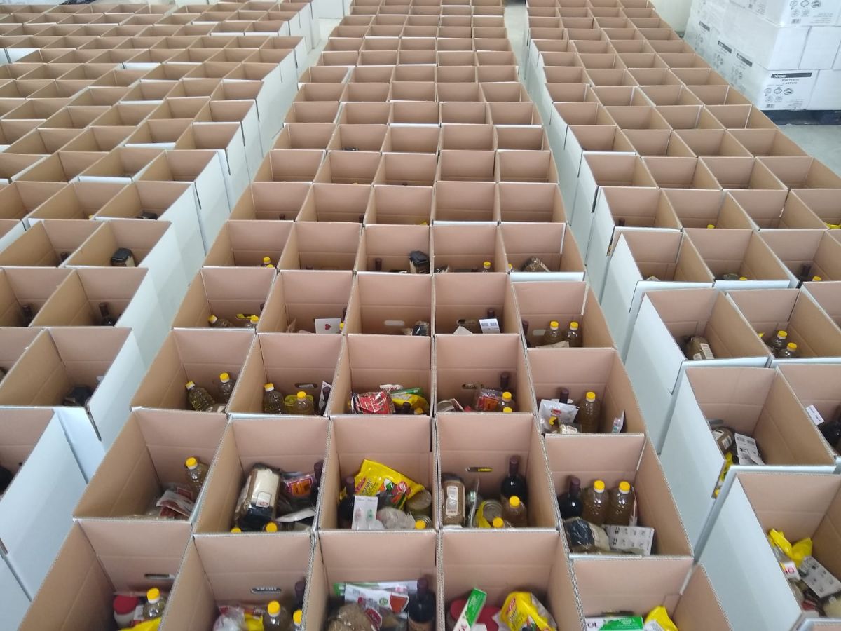 rows on rows of open boxes filled with non-perishable items from food distribution center campaign